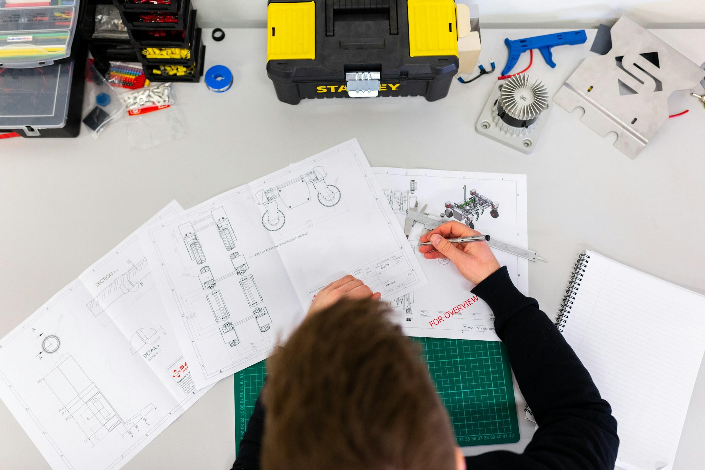 Researcher examining a prototype component in a lab setting